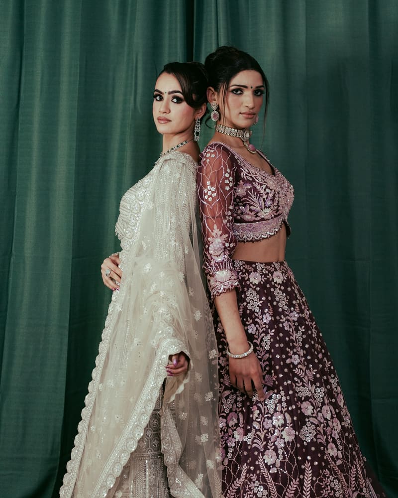 Wine and ivory lehengas at a studio shoot